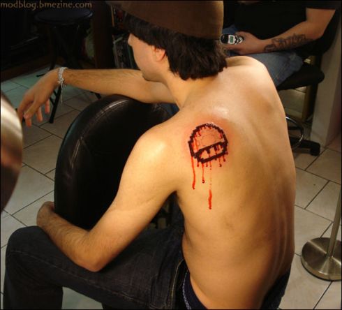  tattoo on his back to prove his allegiance to the gaming character.